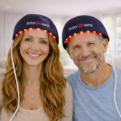 Couple wearing IntoGlowra red light therapy hair growth hats at home showing illuminated 660nm and 830nm LED scalp treatment.